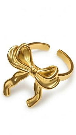 A bold 18K gold-plated adjustable ring featuring a large, realistically draped sculptural ribbon bow.