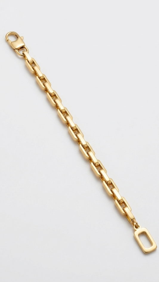 A bold 18K gold-plated rectangular box link bracelet featuring a single open-rectangle charm on a model's wrist.