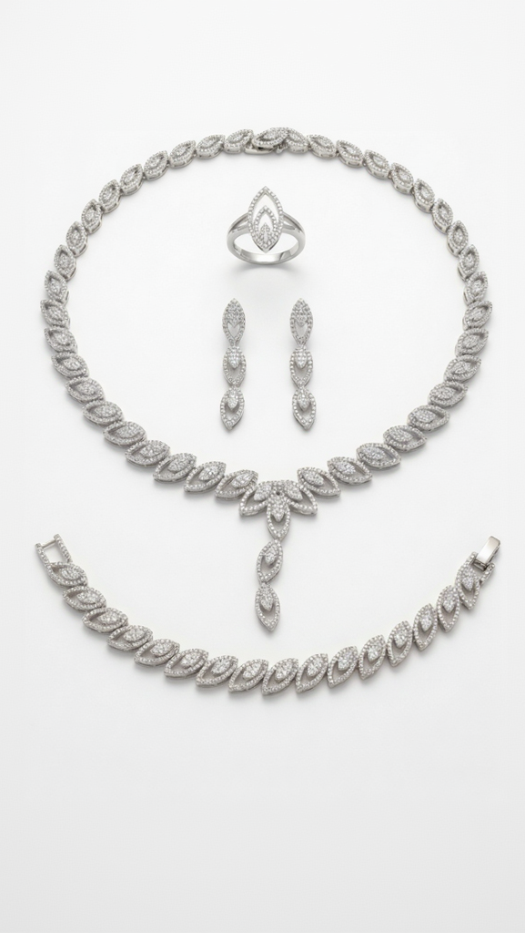 A complete silver-toned bridal suite including a teardrop necklace, matching drop earrings, a tennis bracelet, and a marquise-cut ring.