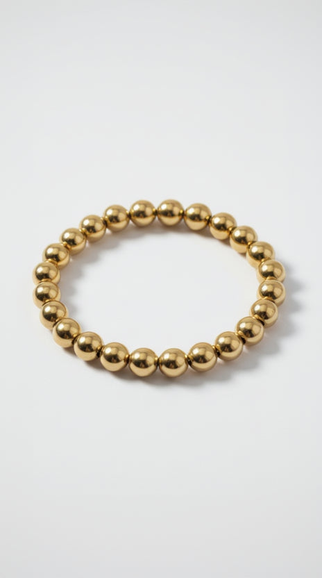 A continuous 18K gold-plated beaded ball bracelet featuring high-polish spheres on a white background.