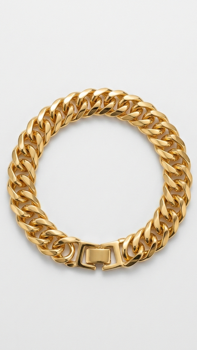 A dainty 18K gold-plated link bracelet with rectangular stations featuring an engraved Greek Key pattern on a person's wrist.