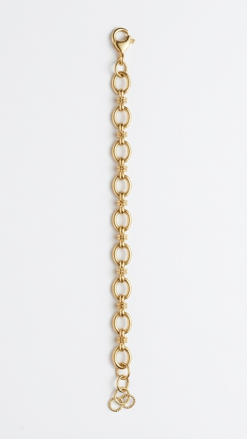A dainty yet detailed 18K gold-plated link bracelet with alternating smooth and ribbed textured gold rings on a model's wrist.