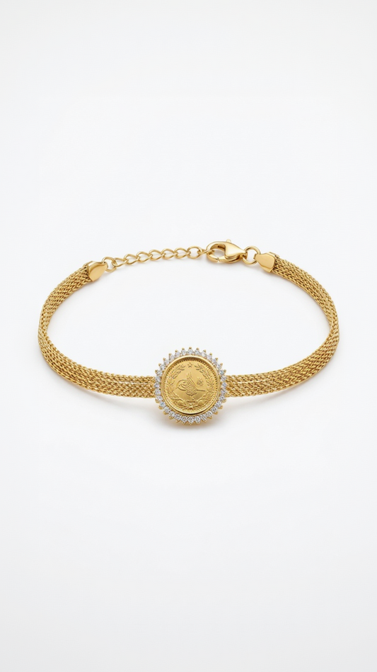 A detailed 18K gold-plated Ottoman coin medallion bracelet with a crystal halo and gold mesh strap on a model's wrist.