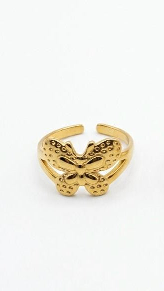 A detailed 18K gold-plated butterfly ring with a textured wing pattern on an adjustable split-shank band.
