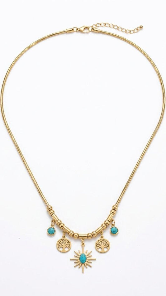 A gold-plated snake chain necklace featuring turquoise-set sunburst and Tree of Life charms on a white background.