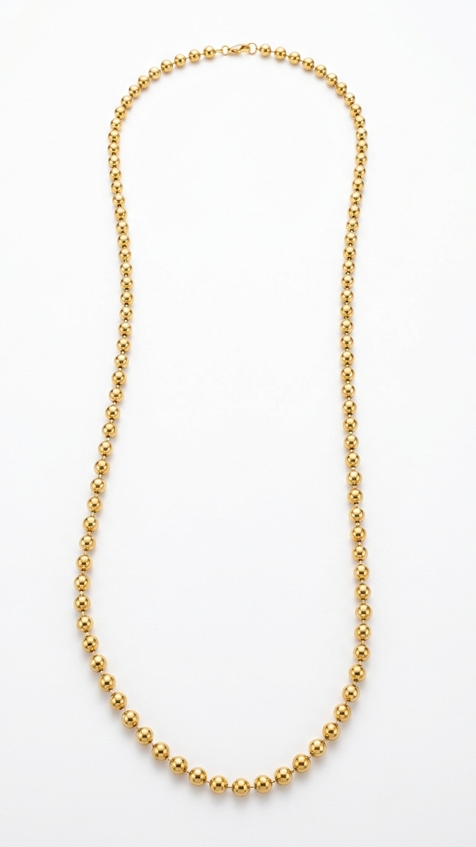 A long 18K gold-plated ball chain necklace featuring uniform polished spheres and a lobster clasp on a white background.
