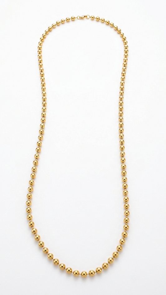 A long 18K gold-plated ball chain necklace featuring uniform polished spheres and a lobster clasp on a white background.