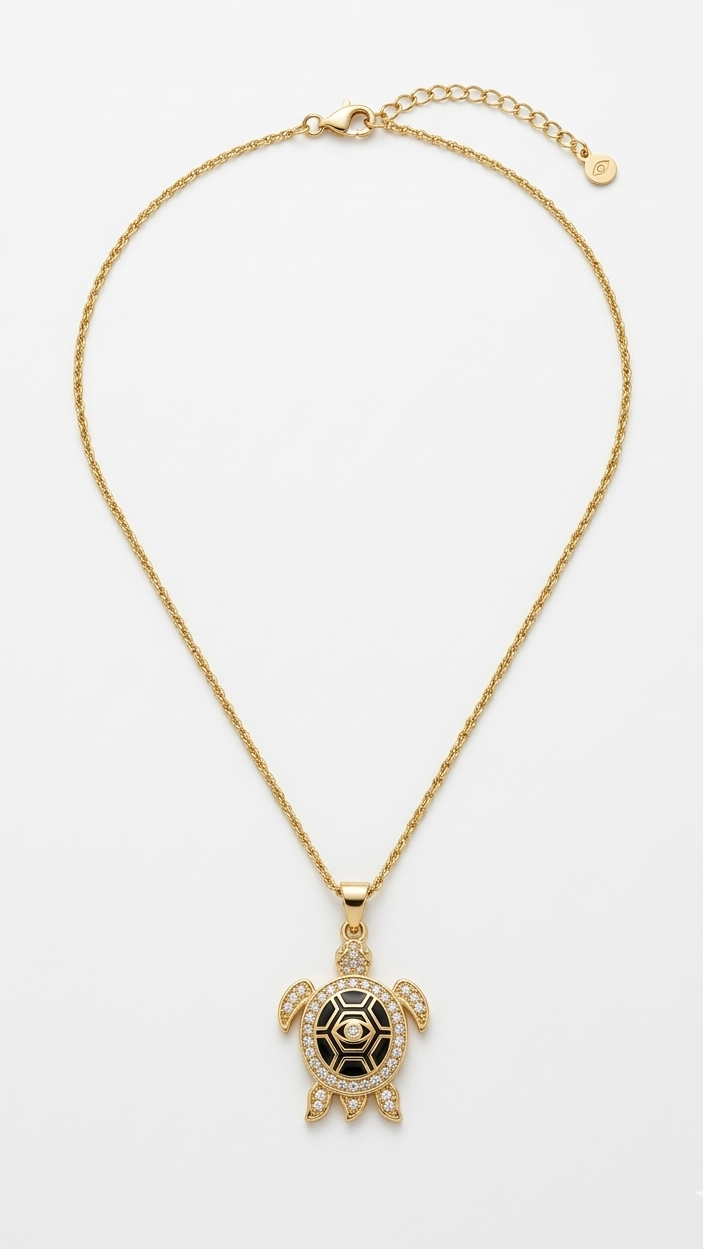 A luxury 18K gold-plated turtle pendant necklace with black enamel shell and crystal pavé details on a model.