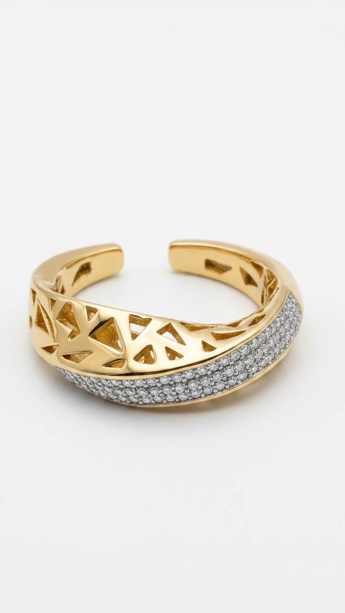 A modern 18K gold-plated open statement ring with geometric triangle cutouts and dark pavé crystal accents on a model's ring finger.
