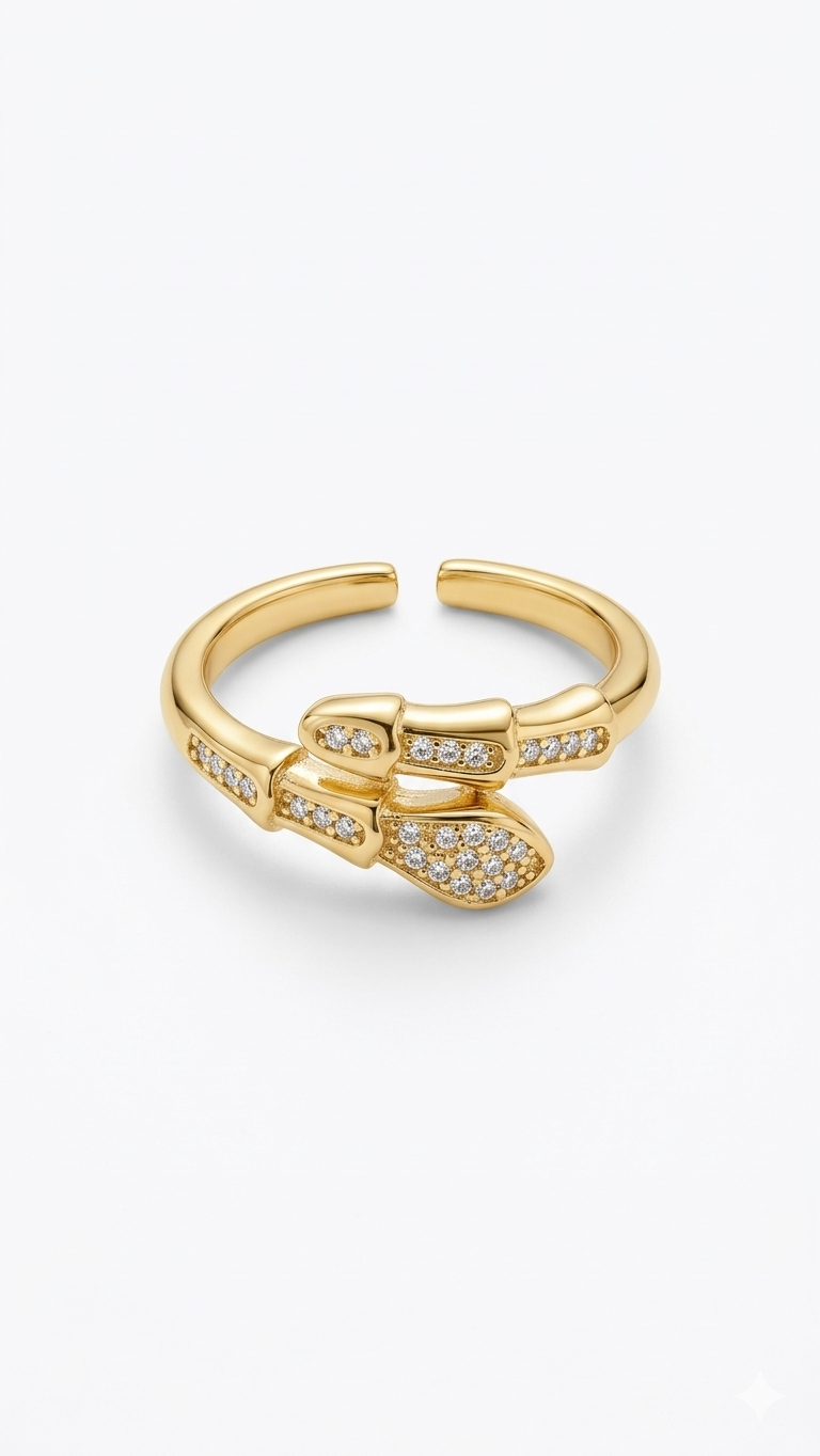 A modern 18K gold-plated serpentine bypass ring with pavé crystal accents on a model's middle finger.
