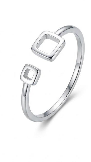 A slender silver-toned bypass ring featuring two open square geometric motifs on a white background.
