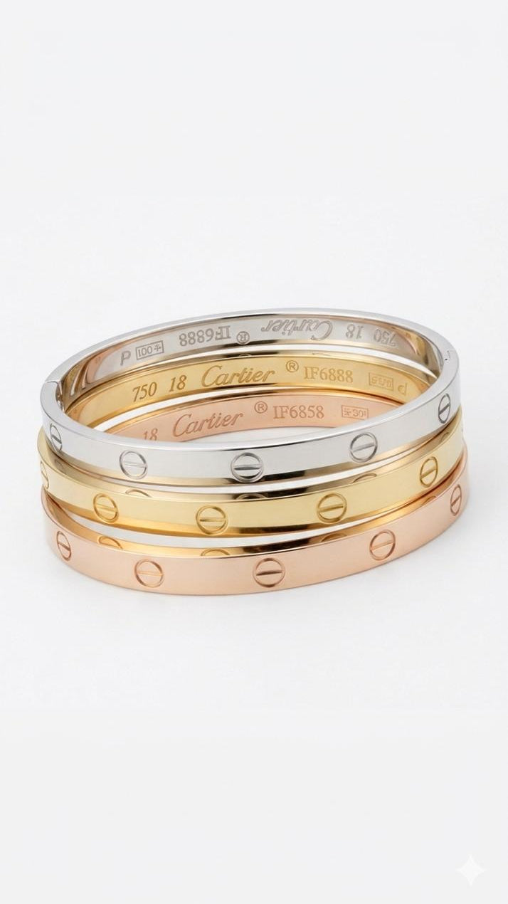 A stack of three bracelets featuring a gold presidential link chain, a silver presidential link chain, and a wide gold flat herringbone bracelet.