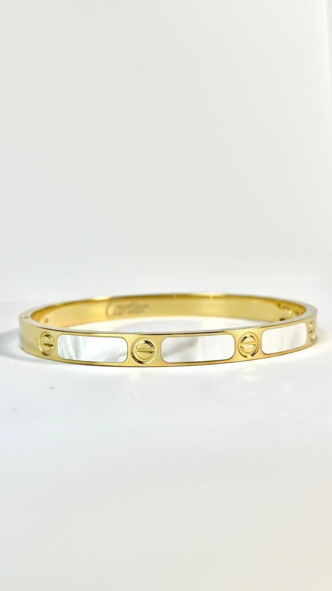 A structured 18K gold-plated bangle with a vertical ribbed (fluted) texture and a high-polish finish on a white background.