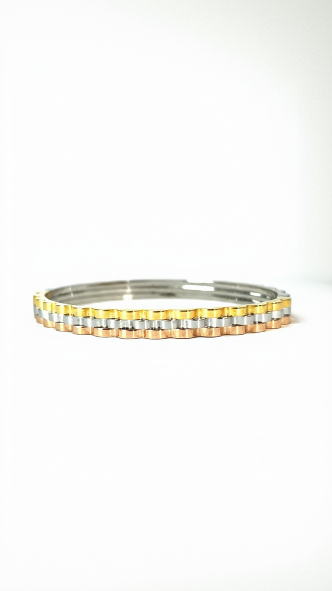 A structured tri-tone bangle featuring fused scalloped bands in yellow gold, rose gold, and silver with a high-polish finish.