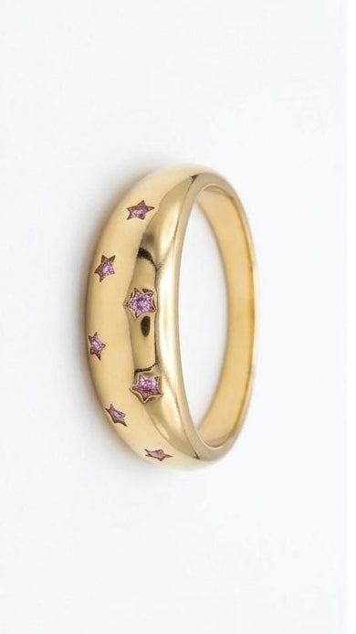 A thick 18K gold-plated dome ring featuring pink pavé crystals set in starburst engravings across the band.