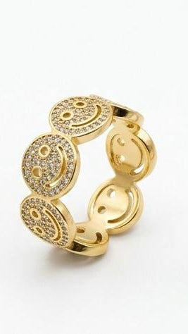 A wide 18K gold-plated eternity ring featuring crystal-encrusted smiley faces in a continuous band.