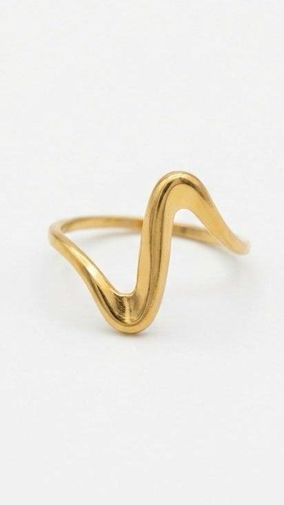 A wide, asymmetrical 18K gold-plated ring with one smooth molten-gold side and one side encrusted in brilliant clear crystal pavé.