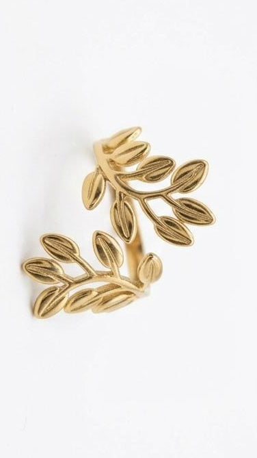 An adjustable 18K gold-plated bypass ring featuring two detailed laurel leaf branches with a soft matte gold finish.