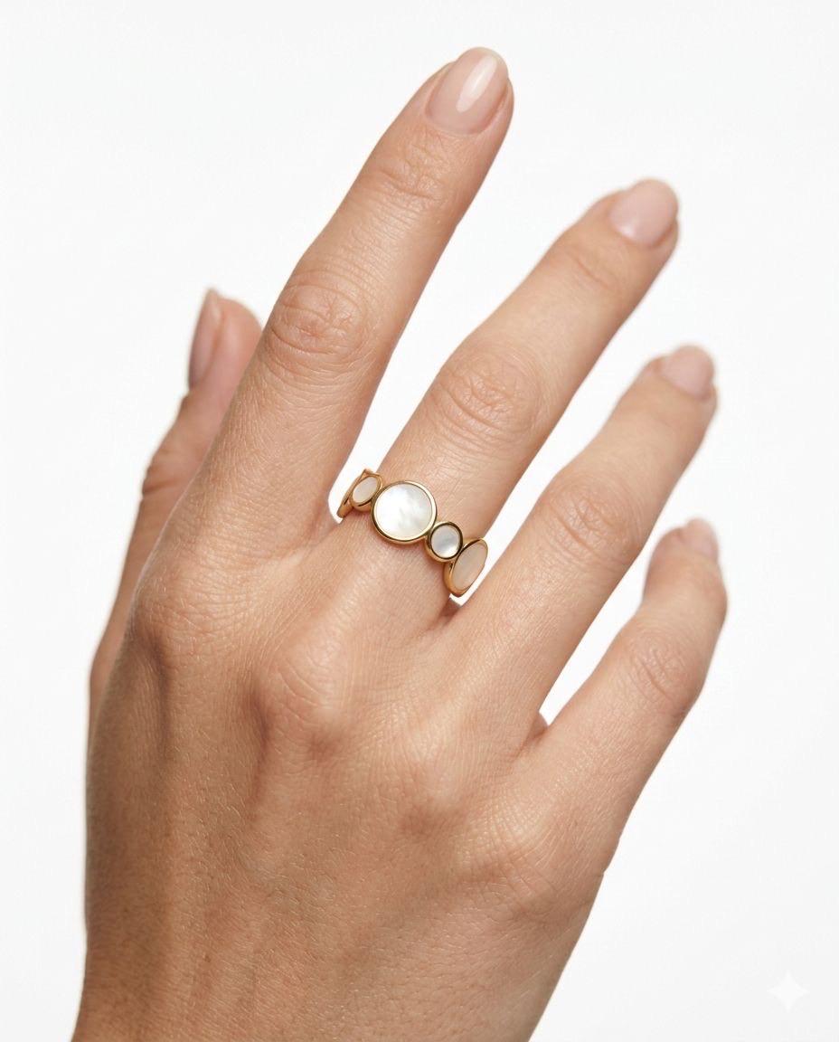 An adjustable 18K gold-plated ring with multiple circular Mother of Pearl inlays in a graduated geometric design.