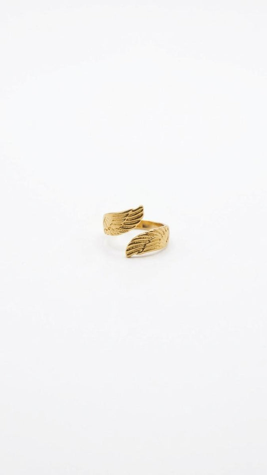 An adjustable 18K gold-plated stainless steel ring featuring an intricate dual-wing bypass design on a white background.