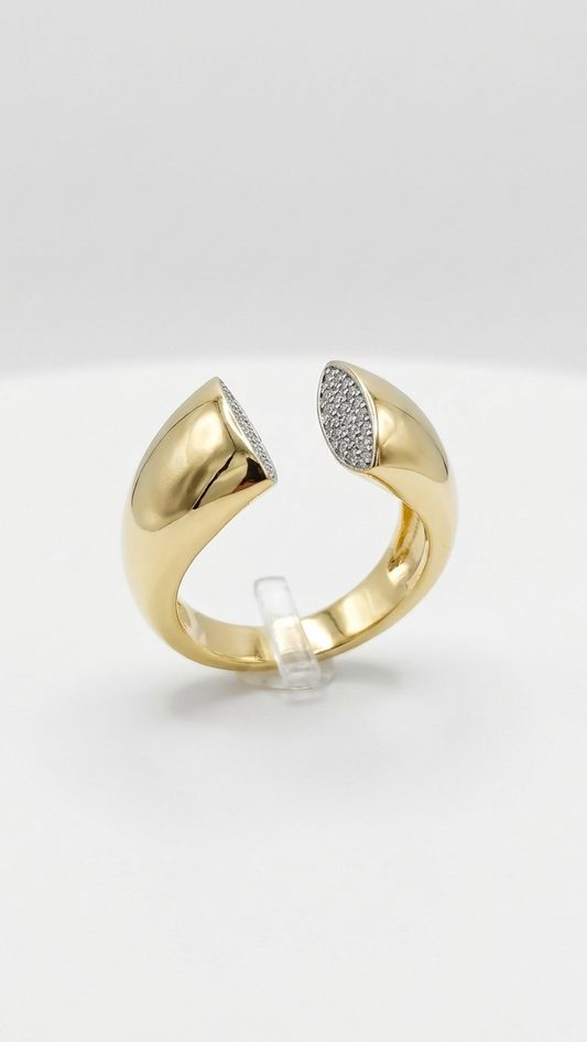 Front view of a sculptural gold open ring with flat diamond-encrusted finials on a jewelry display.