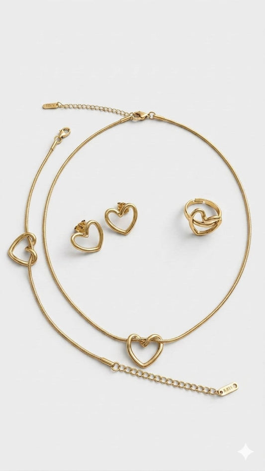 Presteige Accessories complete gold bypass heart jewelry set on a plain background.