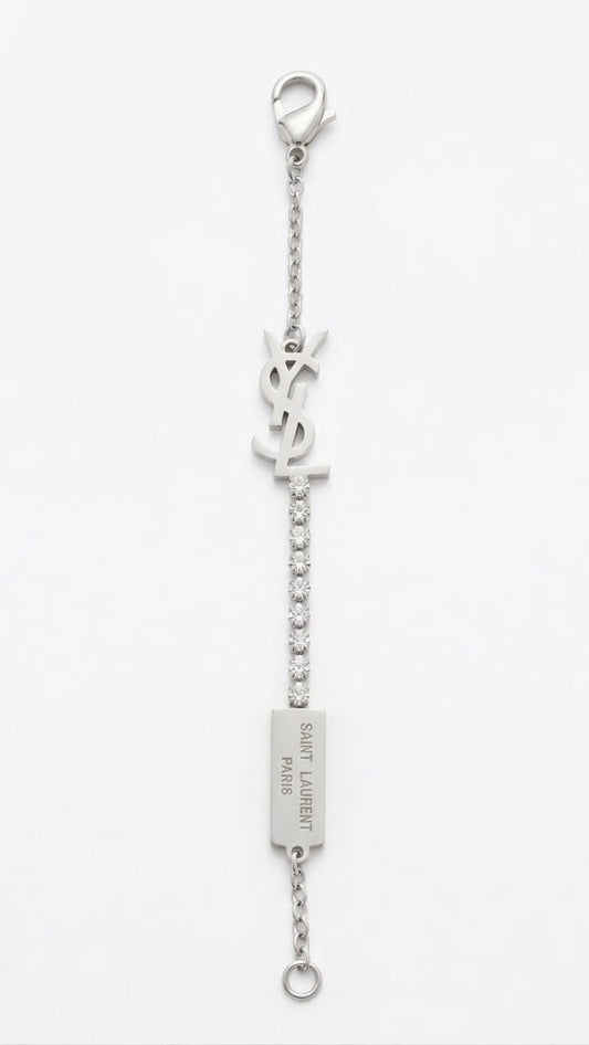 Prestige Accessories silver monogram bracelet with crystals and logo plaque on a white background.