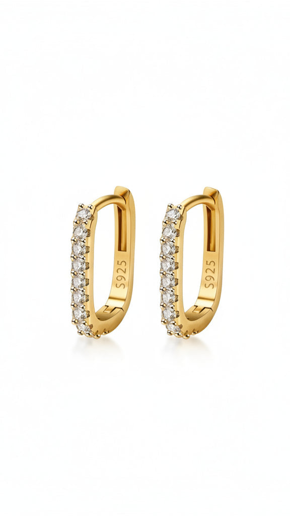 Gold hoop earrings with diamonds on a white background