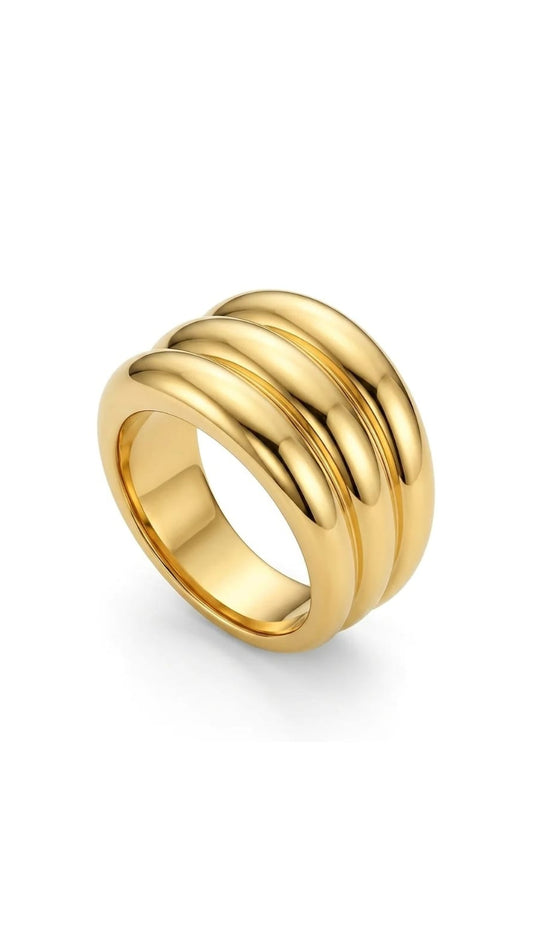 Gold ring with three bands on a white background